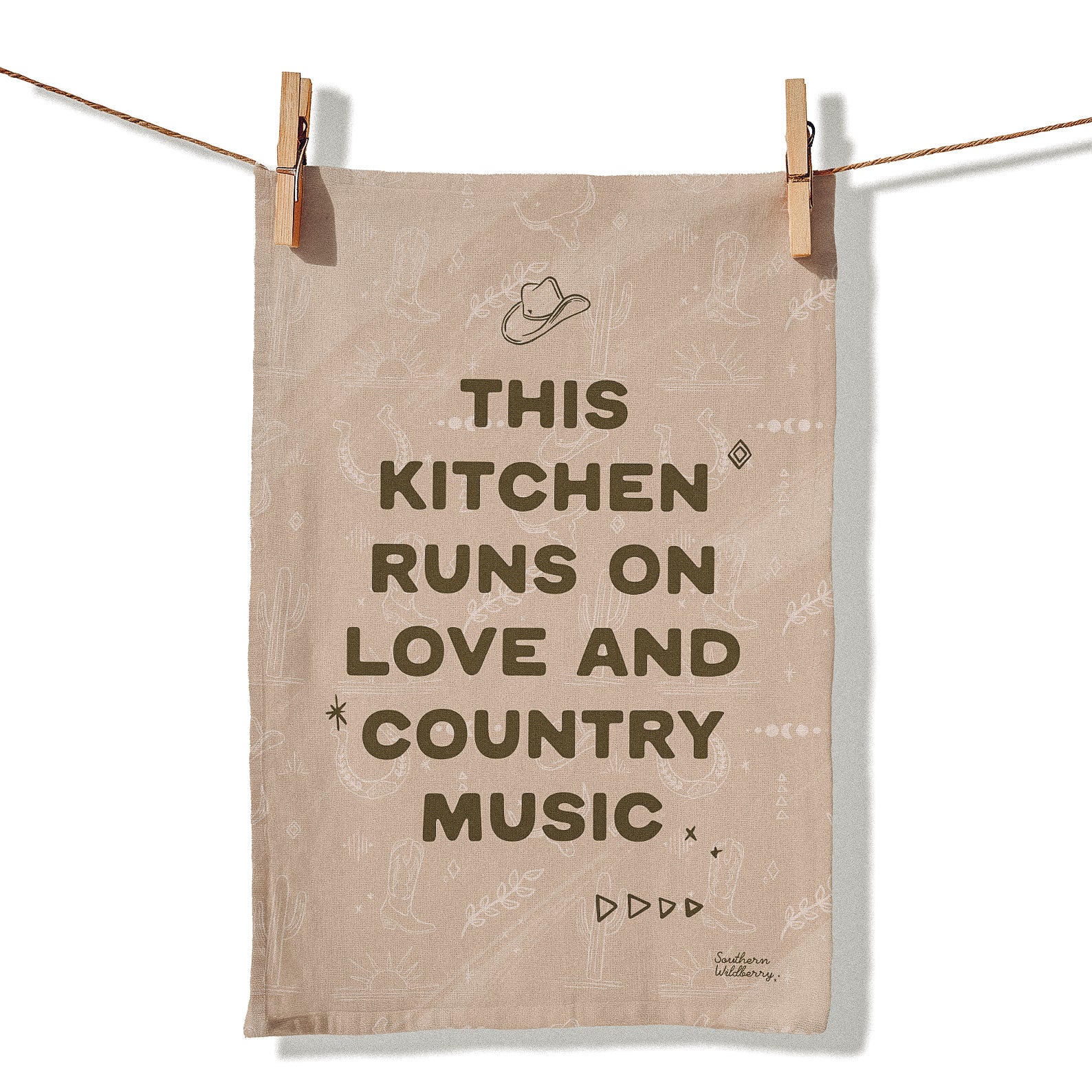 Western tea towel with the quote “This Kitchen Runs On Love And Country Music” featuring cowboy hat and country inspired illustrations in neutral tones